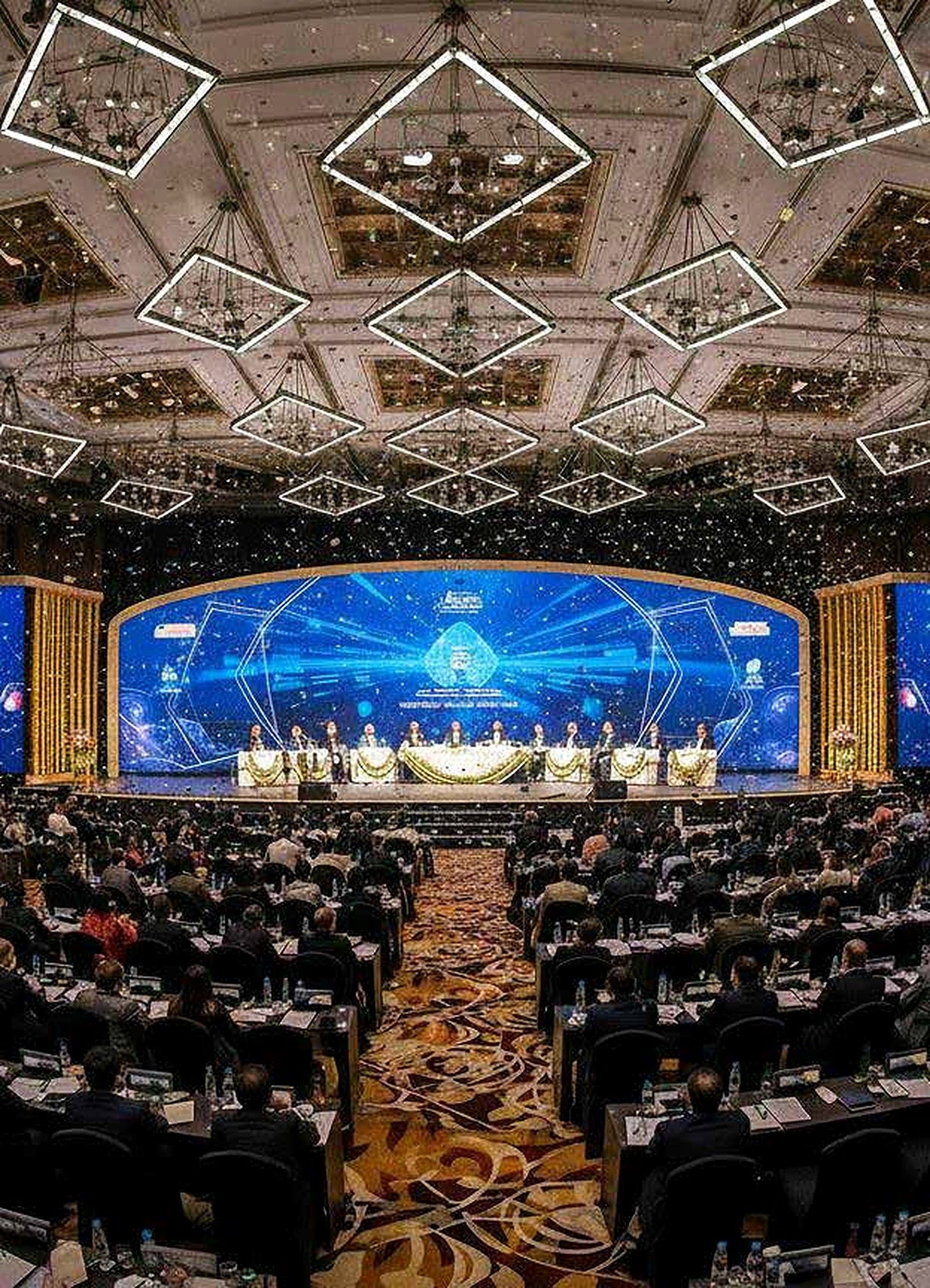 Grand ballroom summit stage with illuminated ceiling installation